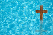 Wooden Cross In Water For Religious Ritual Known As Baptism