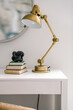 © Ali Harper Photography/Stocksy - Home office work space with gold lamp