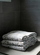 © Ali Harper Photography/Stocksy - Folded towels in a shower