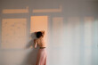 © ula≈ü kesebir & merve t√ºrkan/Stocksy - woman leaning against a wall