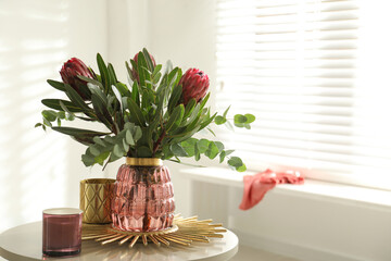 Wall Mural - Vase with bouquet of beautiful Protea flowers on table in room