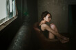 © irina polonina/Stocksy - Asian girl in a dark room.