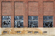 Exterior Brick and Concrete Wall of an Old Factory Building with Broken Windows