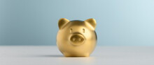 Golden Piggy Bank With Blue Background For Saving And Invest Concept.