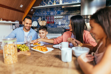 Wall Mural - Latin family eating healthy breakfast in the kitchen