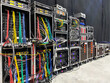 © Purple Moon - Backstage area and tech zone with rack amplifiers, signal splitters, flight cases and radio microphone systems. Professional sound equipment for a concert.