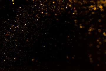 Abstract gold bokeh with black background