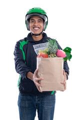 Wall Mural - grocery delivery. courier wearing helmet and jacket uniform holding food isolated over white background