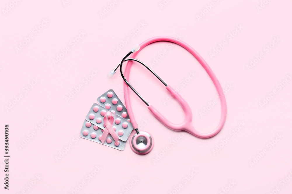 Pink ribbon, remedy and stethoscope on color background. Breast cancer awareness concept