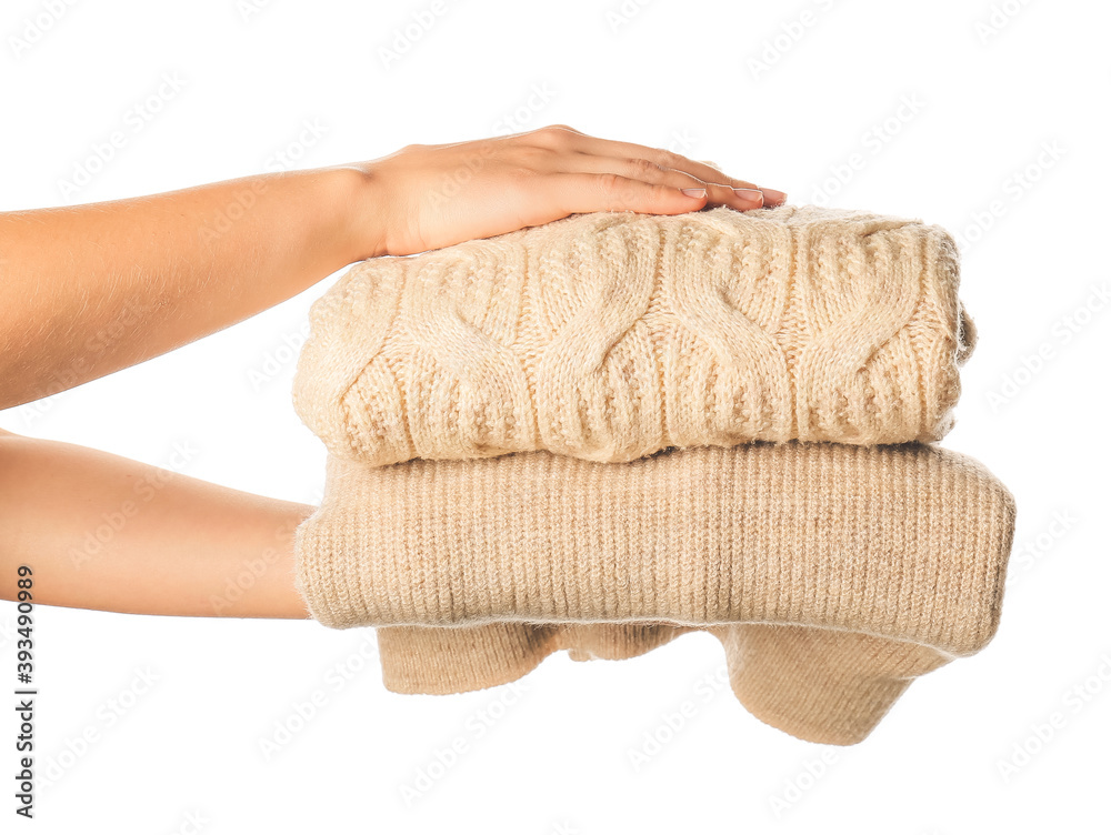 Female hands with warm clothes on white background