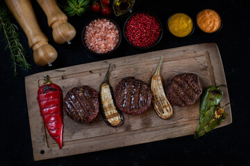 Wall Mural - Delicious grilled meat in the plate with dark background