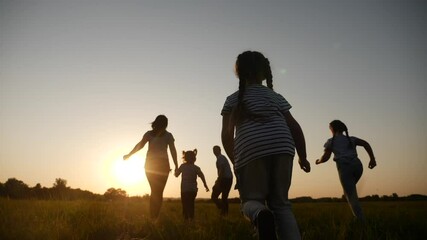 Wall Mural - happy family children kid together run in the park at sunset silhouette. people in the park concept. happy family joyful run. happy family and little baby child summer kid fun dream concept