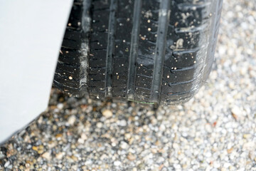 Closeup of the rubber tire in the pebbles background