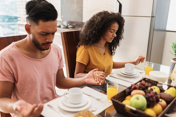 Wall Mural - latin american family having breakfast at home. family praying before eating