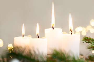 Christmas decoration four burning candle lights at christmas eve. Symbol for a religious ritual at christmas time.