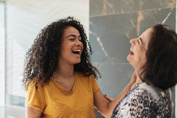 Wall Mural - happy latin american mother and daughter talking