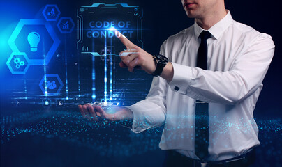 Business, Technology, Internet and network concept. Young businessman working on a virtual screen of the future and sees the inscription: Code of conduct