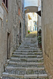 Fototapeta Na drzwi - A narrow street among the old houses of Patrica, a medieval village in the Lazio region, Italy.
