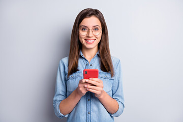 Sticker - Photo of charming person hold phone good mood read nice comments eyewear isolated on grey color background