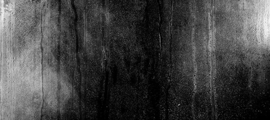 Poster - glass with drops of water on a black background