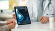 © Gorodenkoff - In a Doctor's Consultation Room: Friendly Professional Doctor Uses Digital Tablet Computer to Show Breast Scan to a Female Patient and Explains Importance of Breast Cancer Prevention. Focus on Tablet