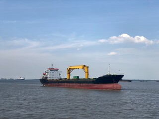 a container ship without cargo is docked in the port area