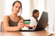 © Vergani Fotografia - Brazilian business woman using credit card and laptop for payment in coworking office. E-commerce, online shopping, communication concept..