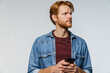 © Drobot Dean - Brooding caucasian redhead guy posing and using cellphone