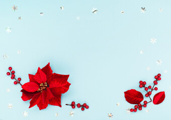 Christmas holiday card - Xmas red flower poinsettia, silver snowflakes, acorns on blue paper background.