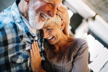 Poster - Happy senior couple in love hugging and bonding with true emotions at home