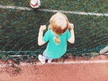 High Angle View Of Girl Standing By Net In Playground