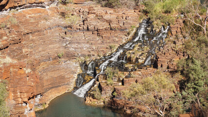 Arid dry red rock landscapes at Dales Gorge within Karijini National Park in the Hamersley Range of Western Australia.