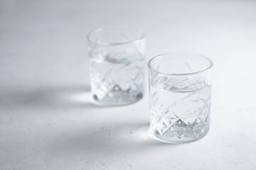 Two glasses of water or transparent liquid on the table healthy lifestyle