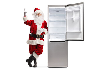 Poster - Santa claus leaning on an empty open fridge and pointing up