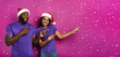 Amazed friends surprised by the arrival of Christmas. Purple background