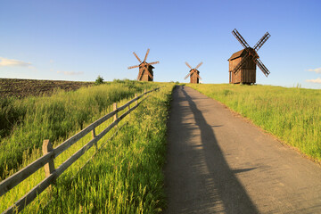 Panoramic view of a windmill in the summer in the field.