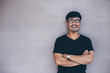 © panitan - portrait young asian man wear eye glasses smiling cheerful look thinking position with perfect clean skin posing on background.fashion people freedom life style concept