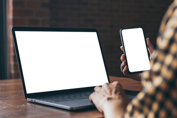 computer,cell phone blank screen mockup.hand woman work using laptop texting mobile. with white background for advertising,contact business search information on desk in cafe.marketing,design