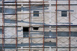 © Prapat - Sunlight and shadow on scaffolding surface outside of high building in construction site