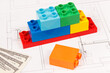 Plastic toy blocks, currencies dollar and construction diagrams of house