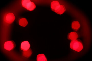 Red bokeh lights on a black background. Christmas lights texture for design