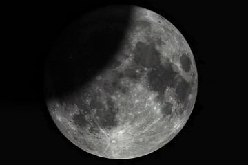 Wall Mural - a large photo of a lunar eclipse through a telescope. moon with high magnification. lunar surface wi