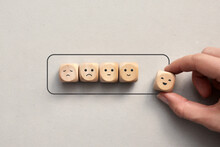 Wooden Cubes With Drawings Of Various Emotions Show The Battery Loading