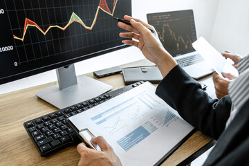 Poster - Business team two colleagues working with computer, discussing and analysis graph stock market trading with stock chart data, financial and investment concept