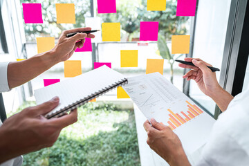 Poster - Young creative team professional using post it notes in glass wall to writing strategy business plan to development grow to success