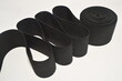 Black Rubber elastic band. Cloth ribbon made of polyester fibre for the production of knitwear textile tapes.