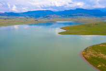 Aerial View Of Woodstock Dam. Reservoir With Spectacular View In The Province Of KwaZulu-Natal. Drakensberg Mountains In The Background, South Africa