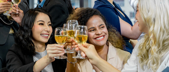  Multiethnic group of women clinking champagne glasses. Business party. Celebration of special occasion.