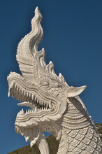 White Chinese Dragan Statue In Front Of Blue Sky