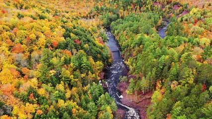Wall Mural - incredible aerial flying over the bad river and a pedestrian bridge towards a horseshoe shaped river